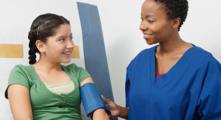 A nurse helping a patient